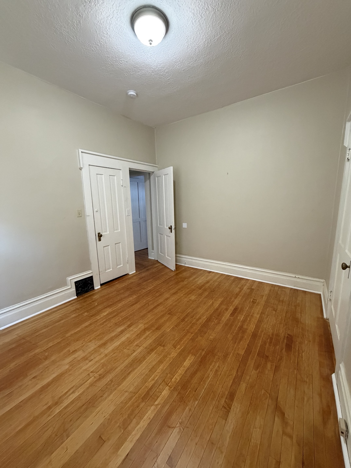 Available bedroom with hardwood flooring